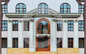 Balcony and windows in row on facade of urban building