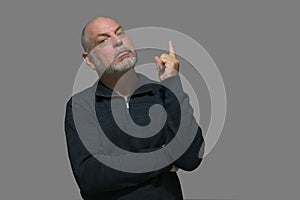 bald adult man pointing upwards ideal for advertising