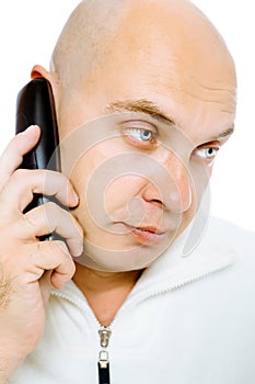 Bald, blue-eyed man with a telephone. Studio. isolated