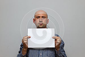 Bald business man is posing with blank copy space