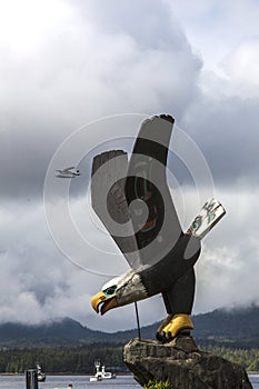 Bald Eagle statue in Ketchikan with float plane in sky