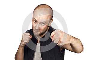 Bald evil guy criminal extortionist preparing for a fight and swinging his fist