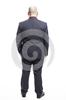 Bald fat man in a suit. Full height. Back view. Isolated over white background.