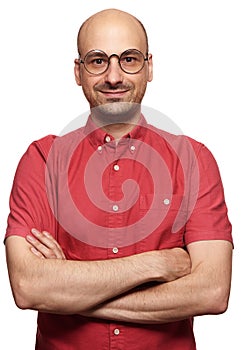 Bald guy smiling and wearing spectacles.