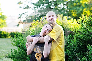 Bald-headed man embraced a girl