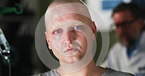 Bald man with cancer crying in hospital
