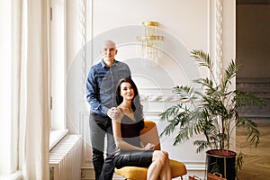 Bald man in a denim shirt and girl