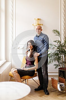 Bald man in a denim shirt and girl