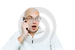 Bald man emotionally communicates by phone. Isolated. Studio