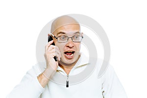 Bald man emotionally communicates by phone. Isolated. Studio