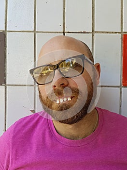 Bald man in eyeglasses with ugly teeth