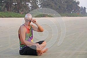 Bald man freak in bright clothes and round glasses at a freak pa