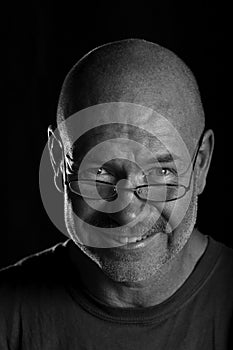 Bald man with glasses in Black and White