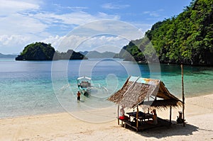 Bald Man pulling wooden traditional filipino boat