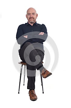 Bald man sitting on white background