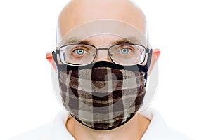 Bald man on a white background in the warm medical mask