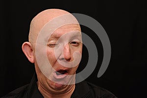 Bald man winking photo