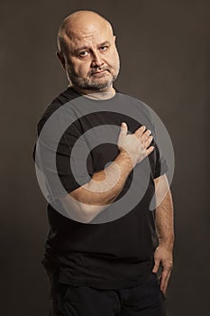 Bald middle-aged man, dark background