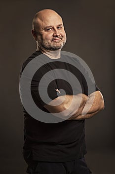 Bald middle-aged man, dark background