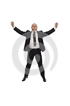 Bald middle-aged man in a suit jumping, businessman, isolated on white background