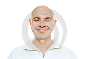 Bald smiling man with his eyes closed. Isolated. Studio