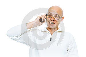 Bald smiling man speaking by phone. Studio. isolated