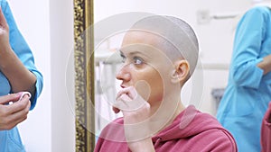 Bald woman at a consultation with a doctor in a clinic. The concept of trichology, oncology, alopecia.
