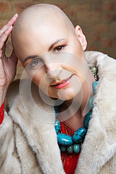Bald woman in fur coat