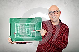 Man with labyrinth on chalkboard