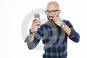 Baldheaded african american man touching moustache and taking selfie photo