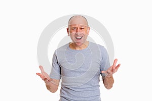 Baldheaded man with open hands looking surprised photo