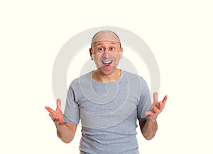 Baldheaded man with open hands looking surprised photo