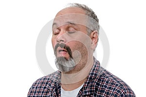 Balding man with beard and plaid shirt snores