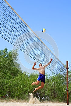 Balding man strikes ball