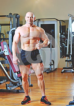 Bale bodybuilder showing thumbs up in gym