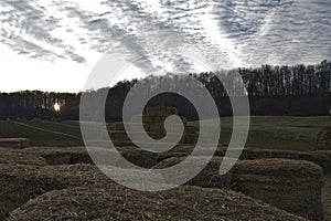 Bale of hay group in a pyramid wall pattern in agriculture farm at sunset