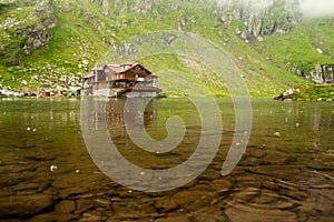 Balea lake with lakehouse on a rainy day