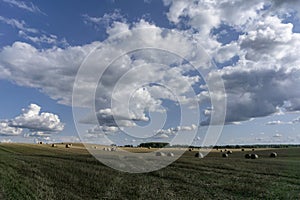 Bales of grain against the background of clouds