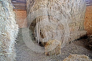 Bales of hay stored on the haywall