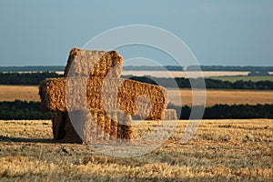 Bales of straw and stubbles on a harvested wheat field