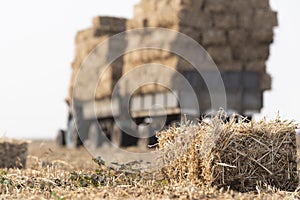 Bales straw in a tractor trailer