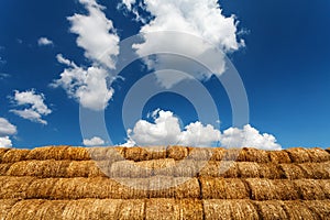 Bales of straw under blue cloudy sky