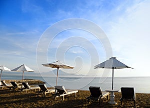 Bali beach resort scene with loungers