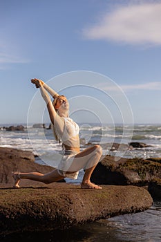 Bali beach yoga. Slim woman practicing Ashwa Sanchalanasana, Equestrian Pose. Fit body. Healthy lifestyle. Self-care concept. Copy