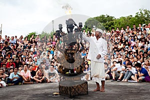 BALI - DECEMBER 30: man lights a fire before traditional Balinese Kecak dance at Uluwatu Temple on DECEMBER