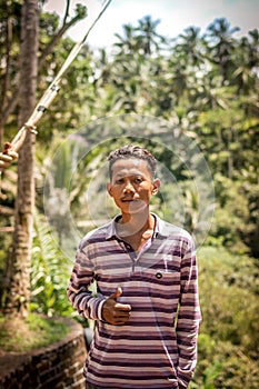 BALI, INDONESIA - DECEMBER 5, 2017: Closeup portrait of asian balinese indonesian man in the jungle of Bali island.