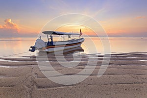 Bali, Indonesia. Fishing boats populate the shoreline at the Sanur Beach photo