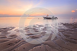 Fishing boats populate the shoreline at the Sanur Beach Indonesia photo