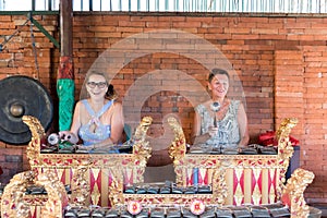 BALI, INDONESIA - MAY 5, 2017: Women playing on Traditional Balinese music instrument gamelan. Bali island, Indonesia.