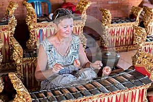 BALI, INDONESIA - MAY 5, 2017: Women playing on Traditional Balinese music instrument gamelan. Bali island, Indonesia.